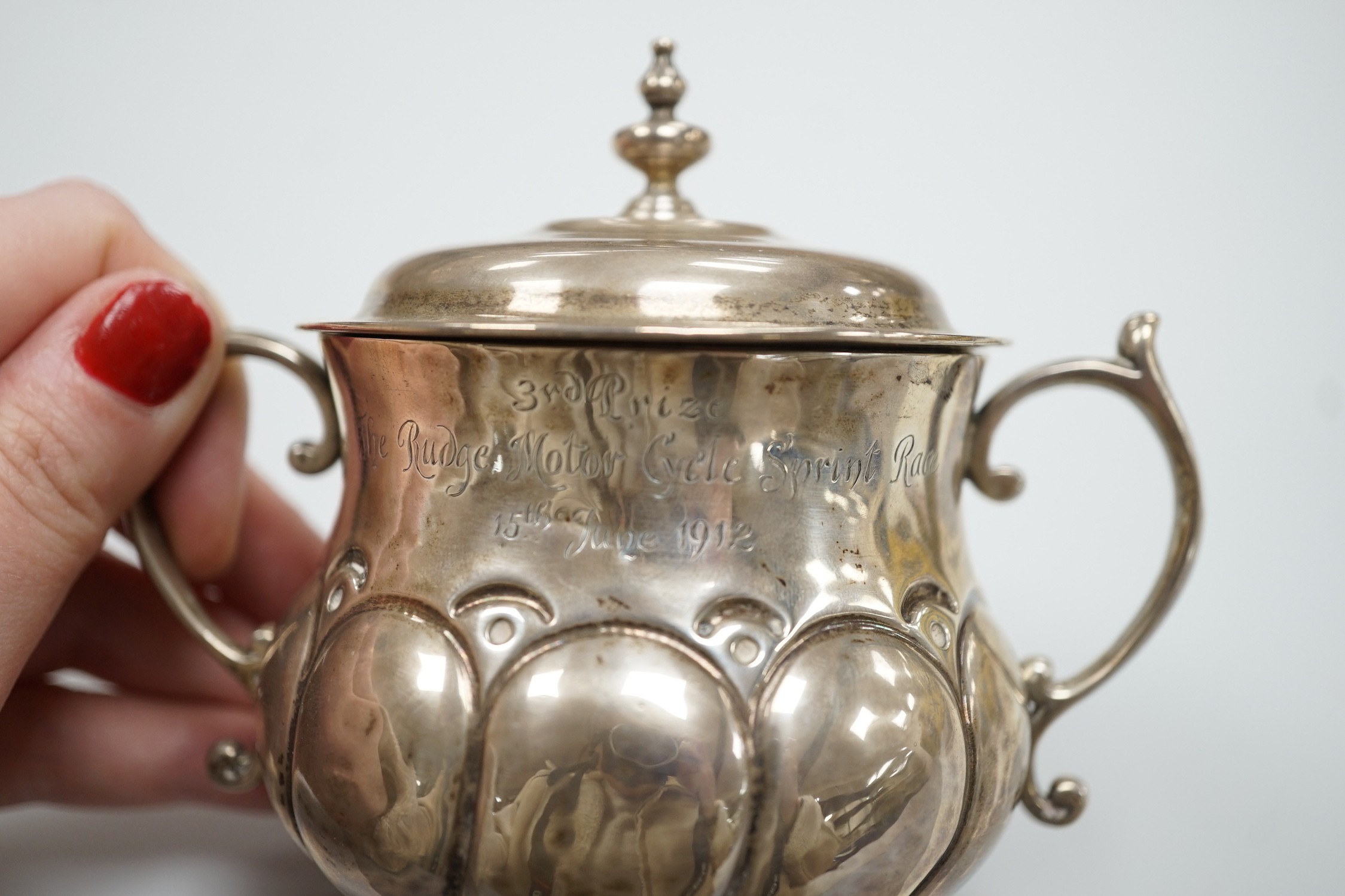 A George V silver presentation porringer and cover for the 'Rudge Motorcycle Sprint Race at Brooklands 13th of June 1912, third prize' William Comyns, height 10.5cm, 6.1oz.